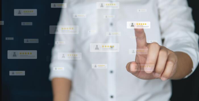 Satisfied customer celebrating in front of laptop in shared workspace Satisfied customer celebrating in front of laptop in shared workspace